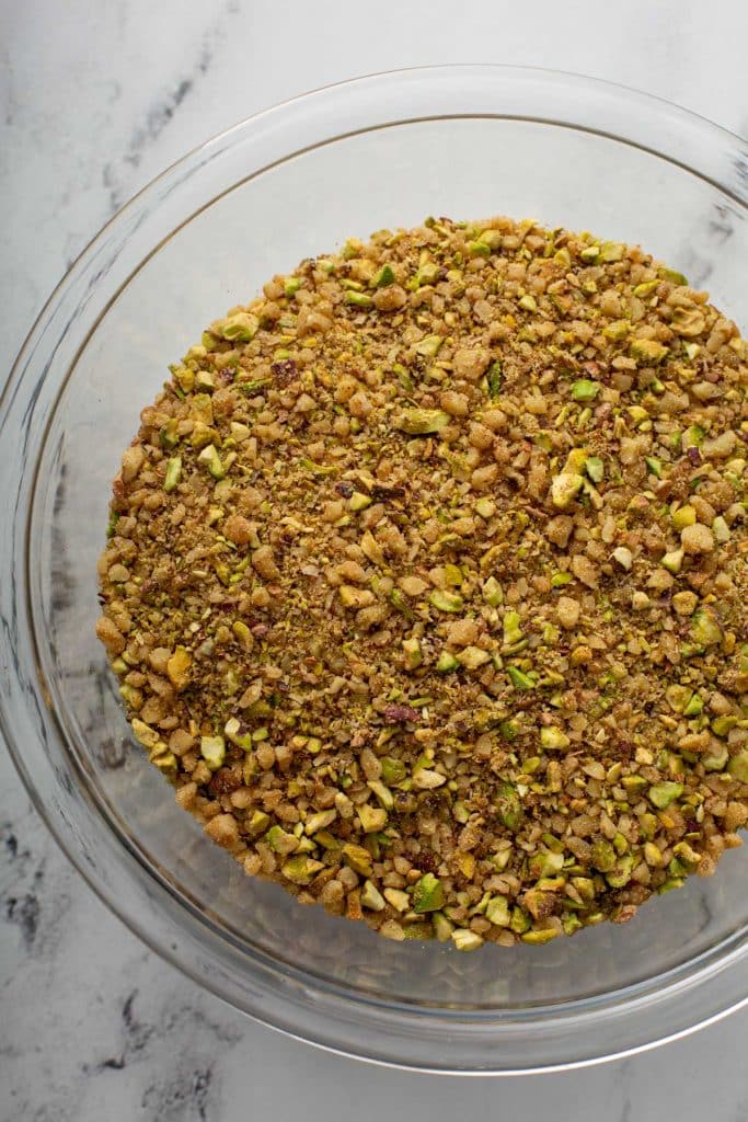 A glass bowls filled with finely chopped nuts