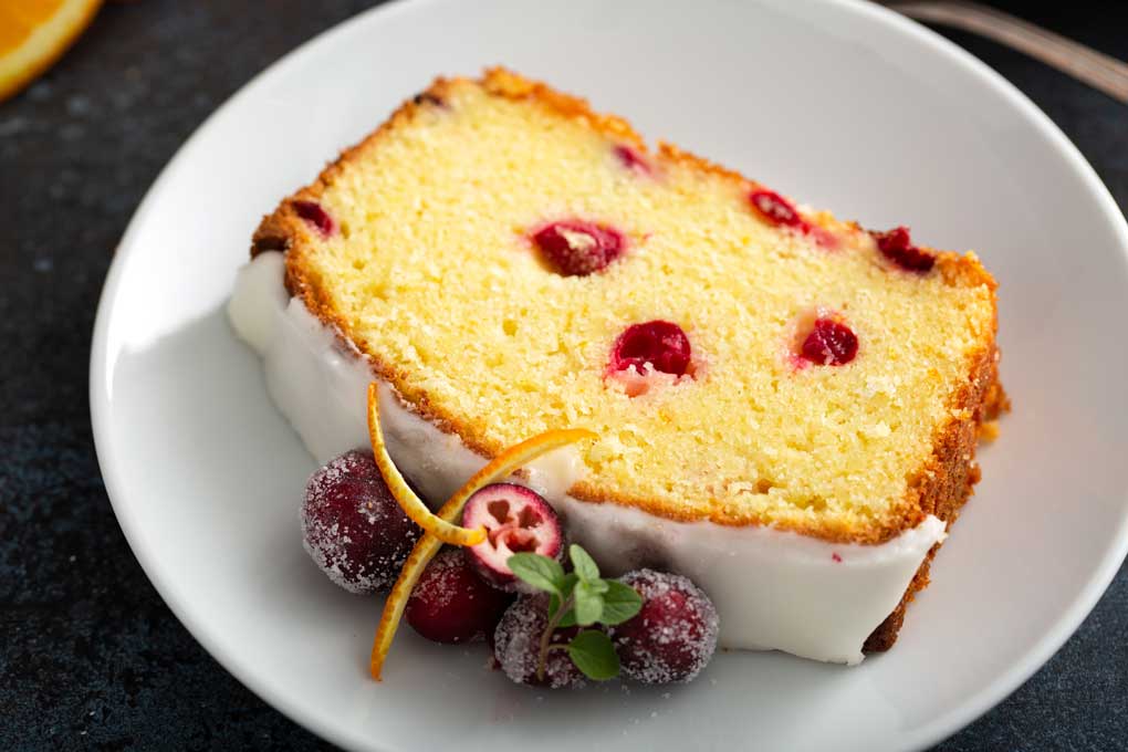 Slice of cranberry loaf on a white plate