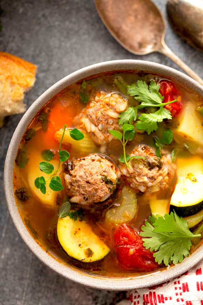 A bowl with Albondigas Soup garnished with cilantro