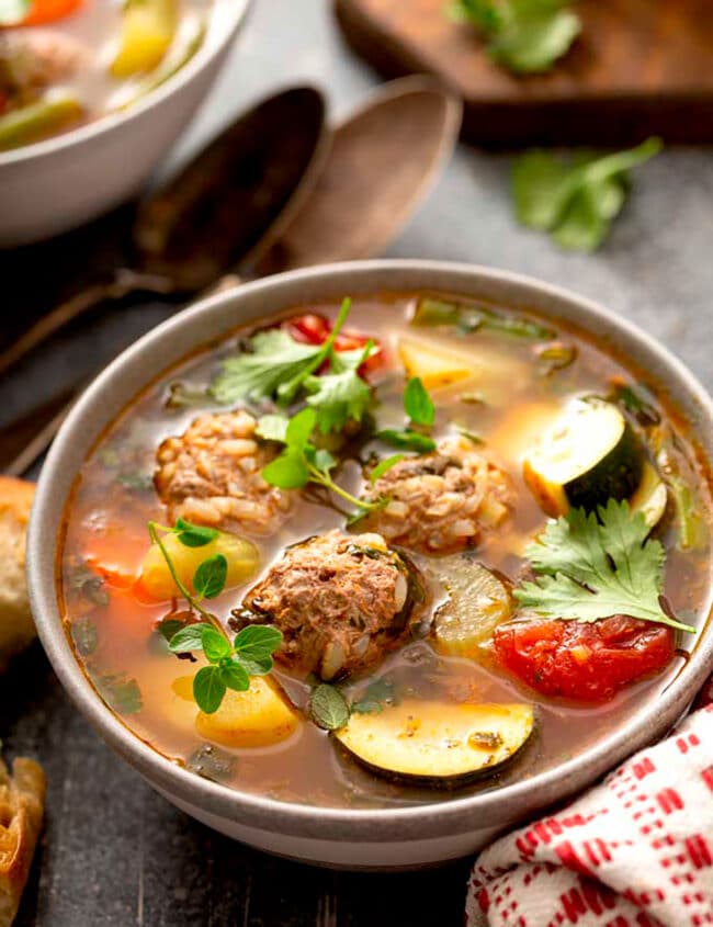 A bowl of Mexican Meatball Soup garnished with cilantro