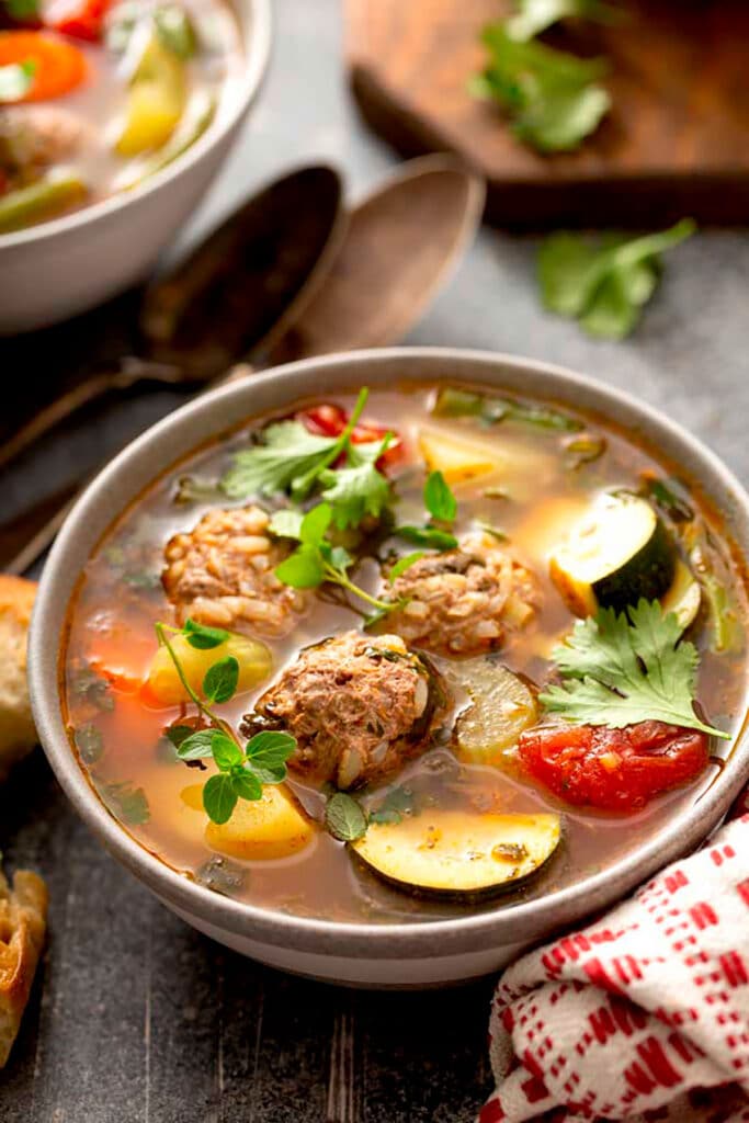 A bowl of Mexican Meatball Soup garnished with cilantro