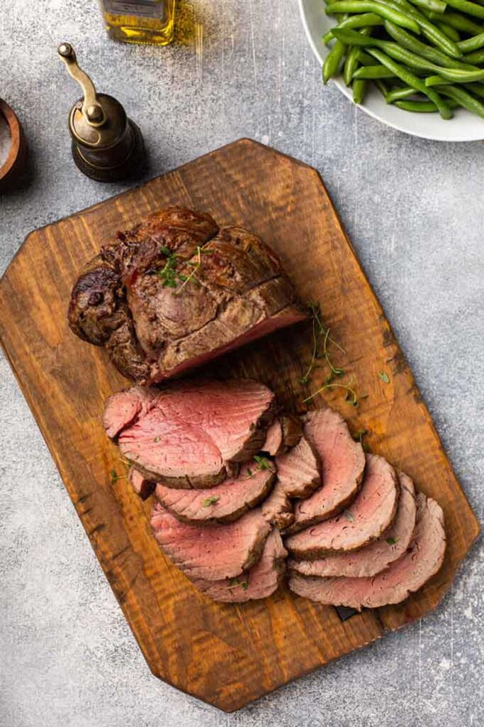 Top view of a tenderloin of beef on a cutting board