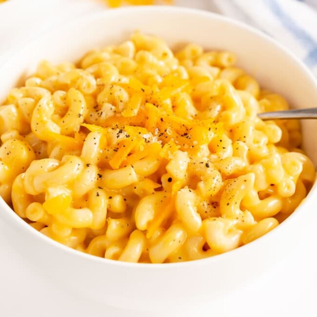 white bowl with cheesy instant pot mac and cheese.