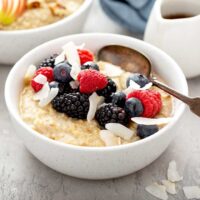 Bowl of steel cut oats breakfast cereal topped with berries