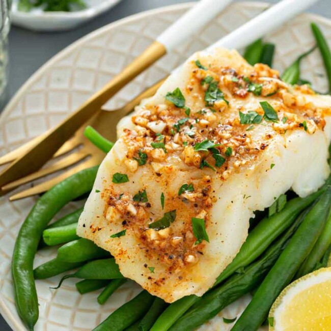 Filet of cod baked with Cajun butter served on a bed of blanched green beans