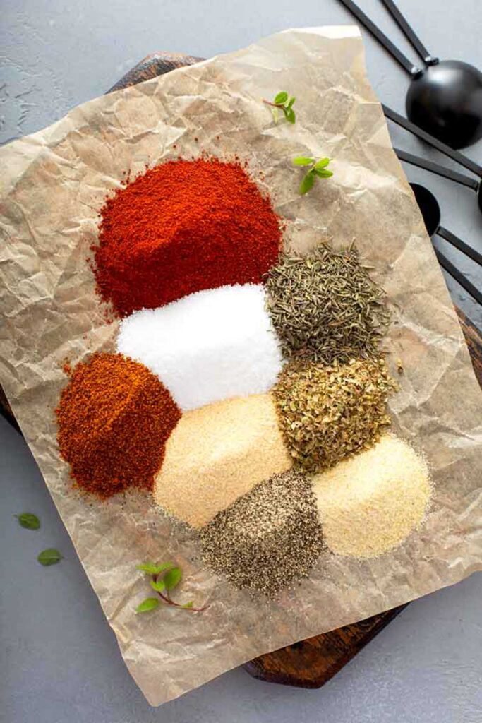 different spices on a piece of parchment paper