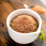 A white bowl filled with homemade cajun seasoning mix