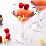 A couple of glasses with French martini garnished with braspberries
