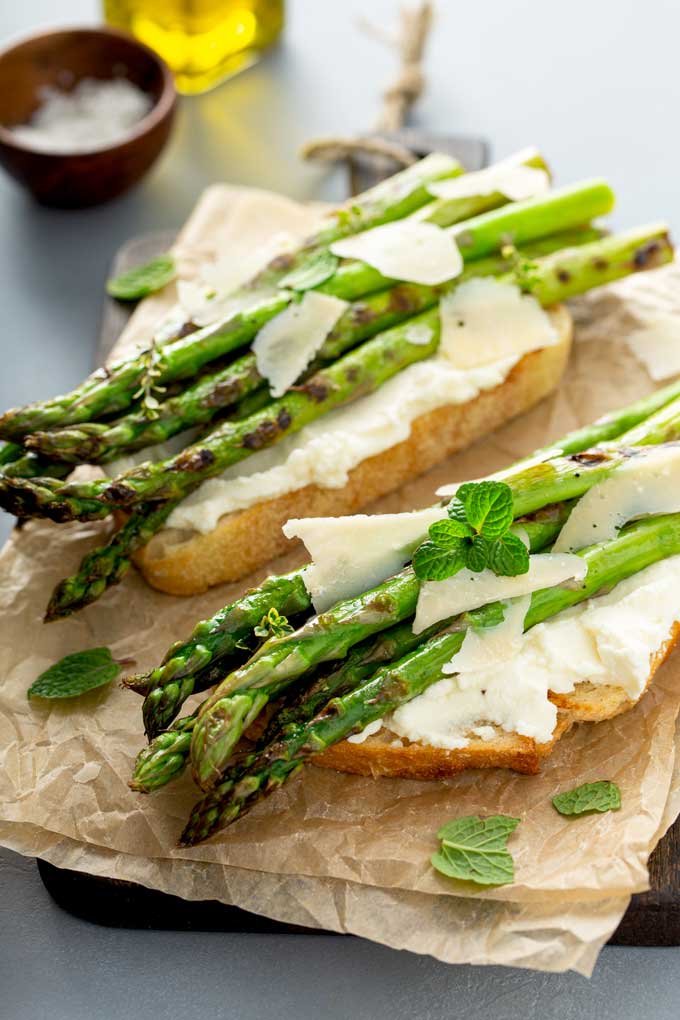 Grilled asparagus on top of ricotta crostini with Parmesan cheese