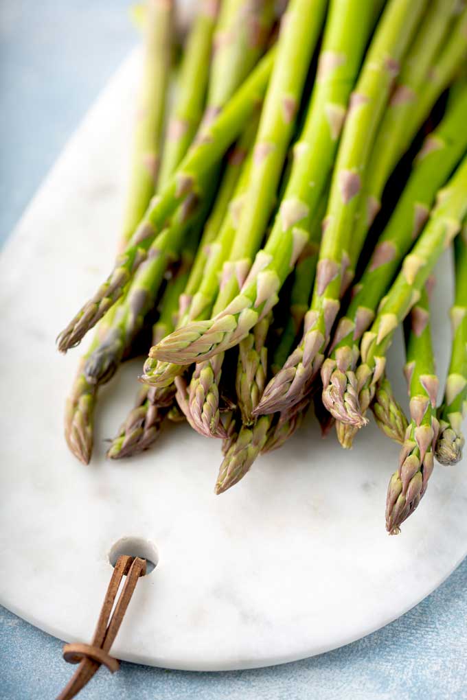 Fresh asparagus on a white board