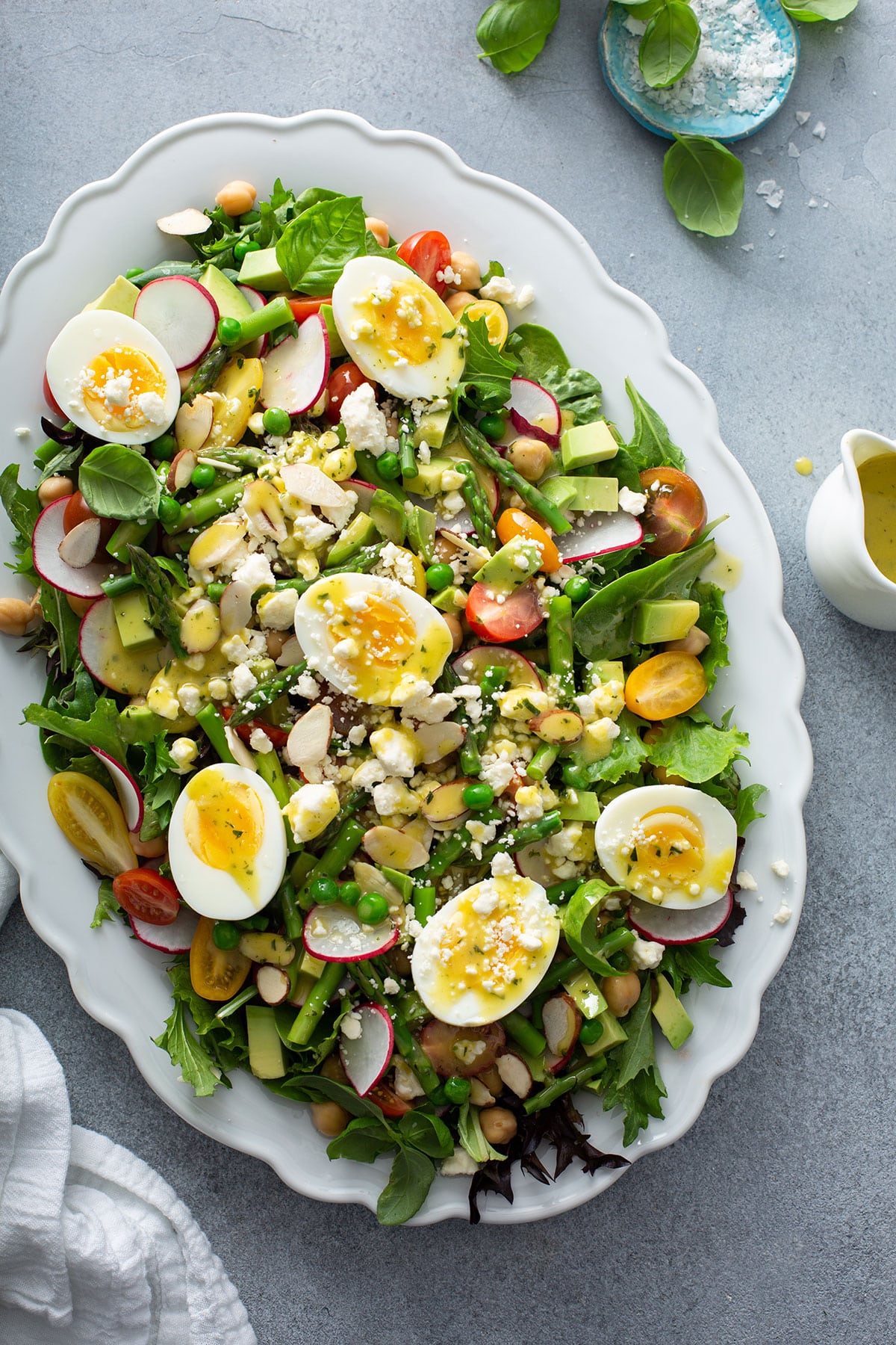 Top view of a spring salad with hardboiled eggs, asparagus and radishes.