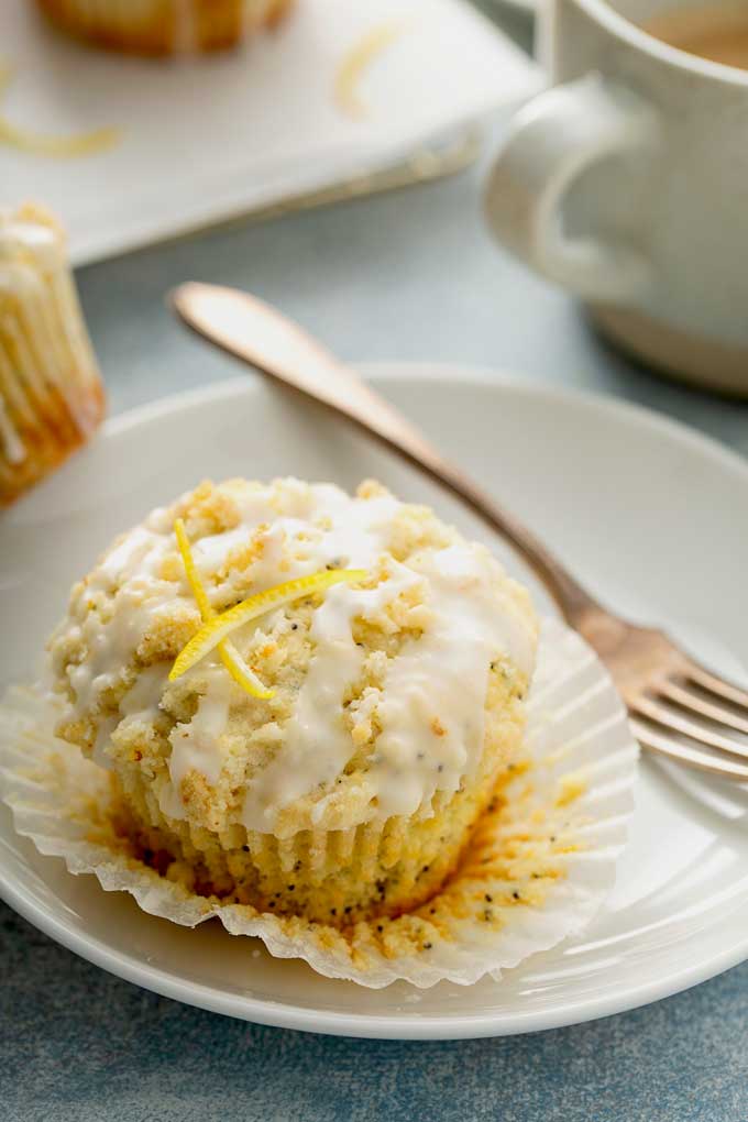a lemon poppy seed muffin with graze on a white plate
