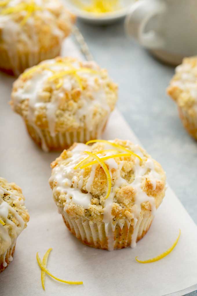 Lemon muffins on a piece of parchment paper.