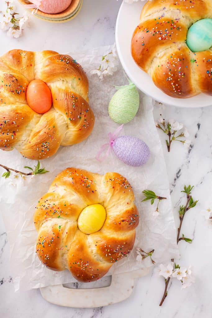 Top view of three wreaths of soft brioche style Easter Italian sweet bread