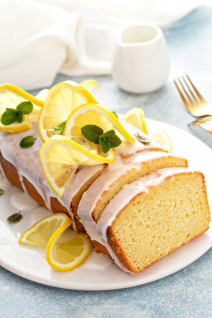 A loaf of lemon quick breas with glaze sliced.