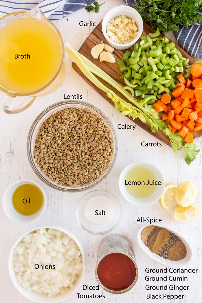 Ingredients to make lentils soup on a white wooden board