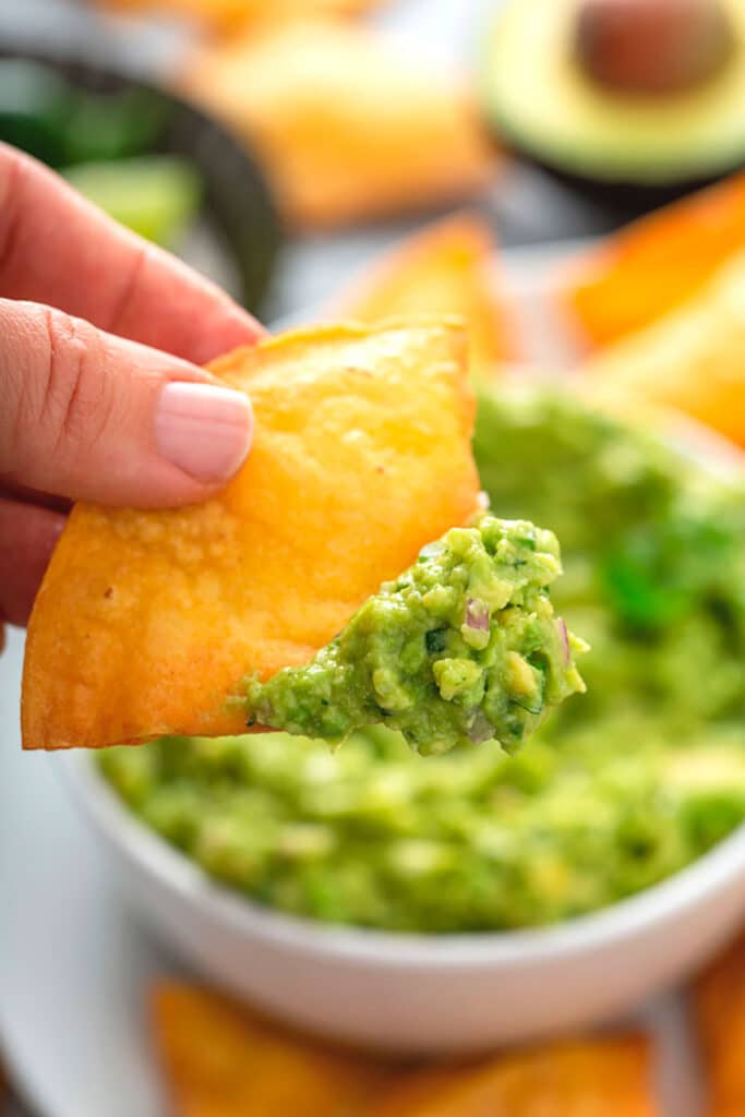 a close up view of a Homemade Tortilla Chip with guacamole