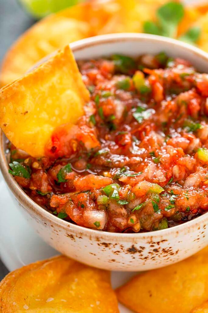 Fresh restaurant-style Mexican Salsa served in a bowl with Tortilla Chips