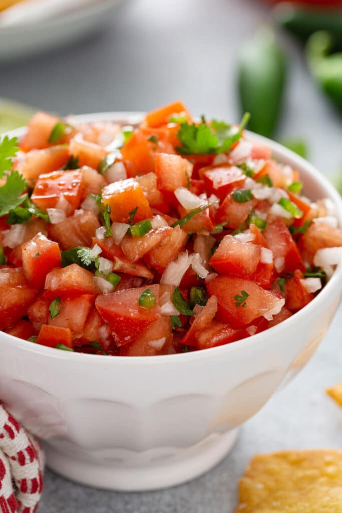 Close view of homemade Pico de Gallo on a white bowl