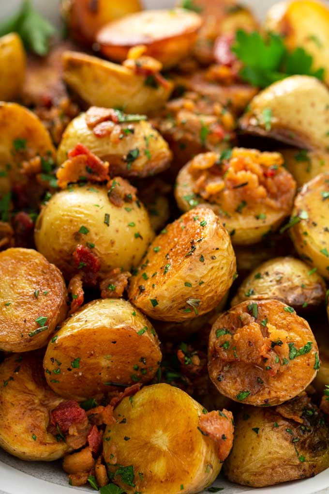 Close up view of skillet potatoes with bacon and herbs