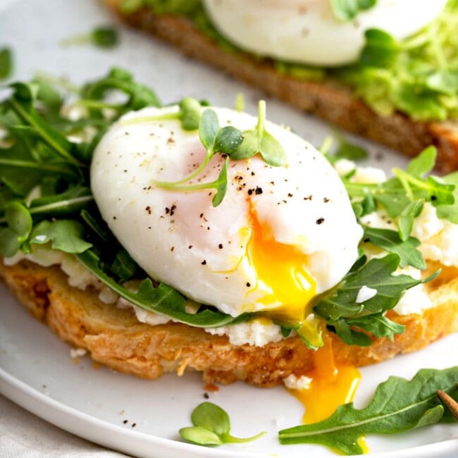 Soft poached egg with runny yolk on toast