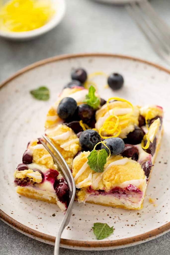 Cheesecake  and streusel blueberry lemon bar on a plate