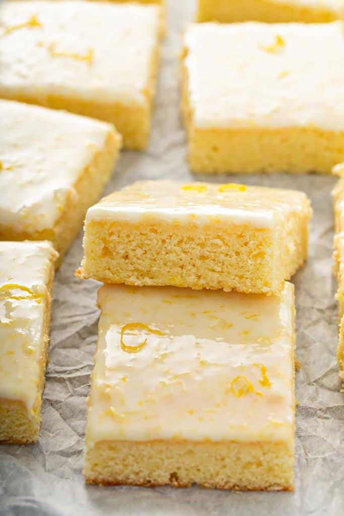 close up view of lemon brownies over parchment paper