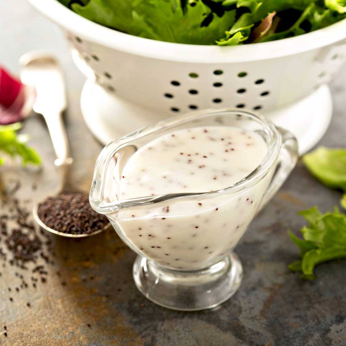 small glass pitcher with lemon poppy seed dressing