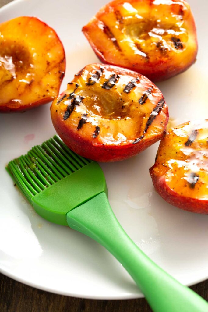 Grilled peaches brushed with sticky peach glaze