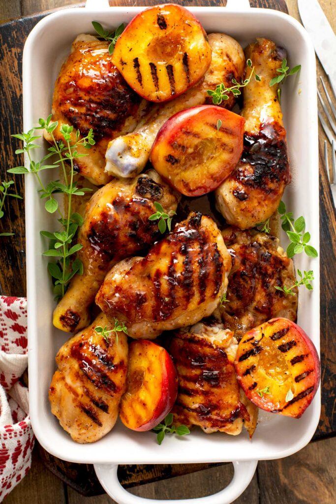 White Ceramic container filled with peach glazed grilled chicken