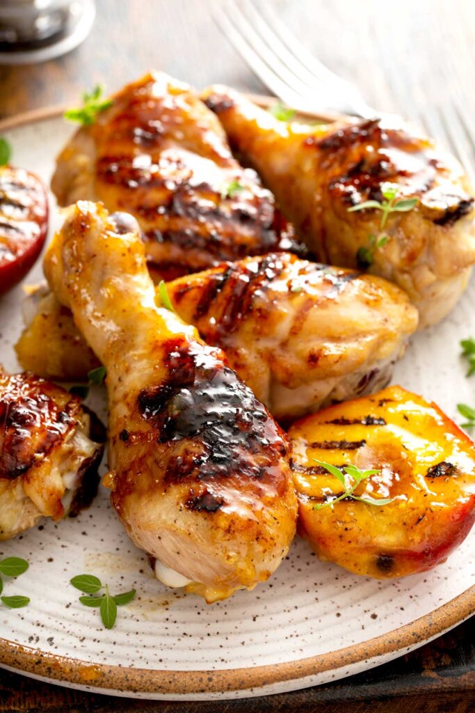 Plate with grilled chicken pieces smothered in peach glaze