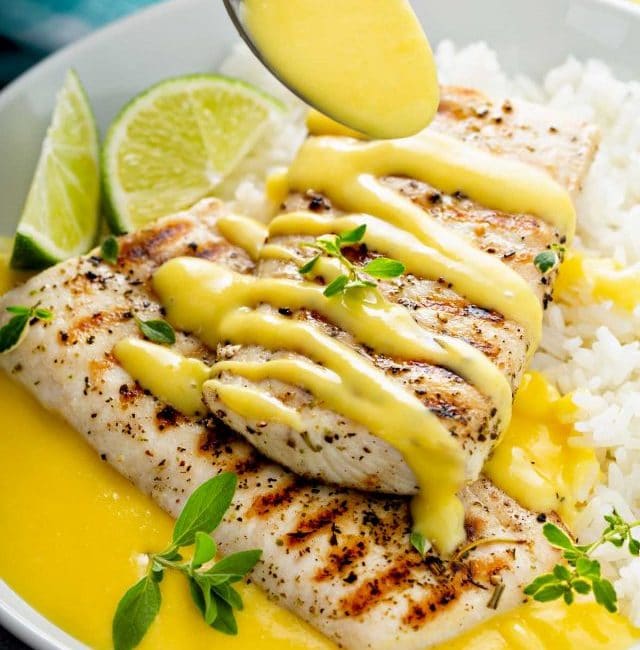 Mango lime wine butter sauce poured over grilled mahi mahi served with rice