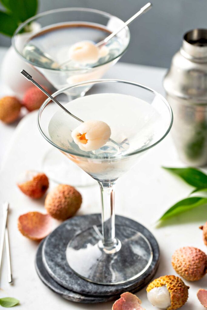 A martini glass with exotic lychee martini garnished with fresh lychee