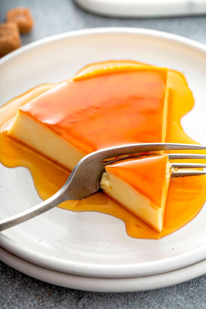 a fork scooping a piece of Spanish Flan