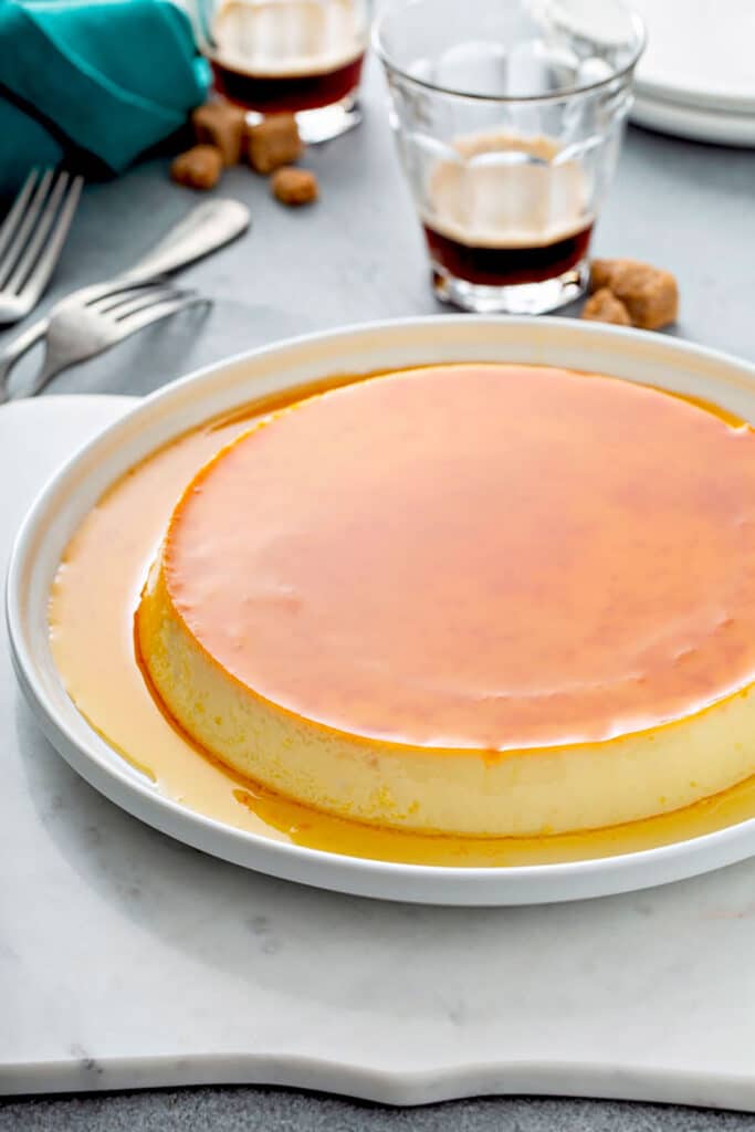 Spanish Flan on a white plate with caramel on top