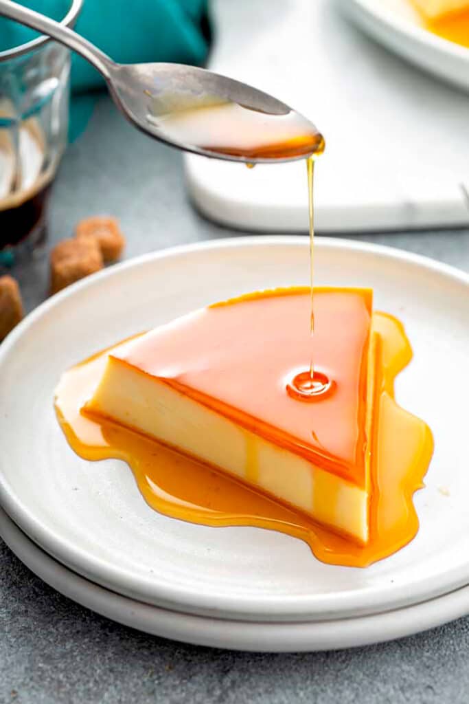 Caramel sauce poured over a slice of Spanish Flan