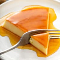 Rich and creamy flan with caramel on a white plate