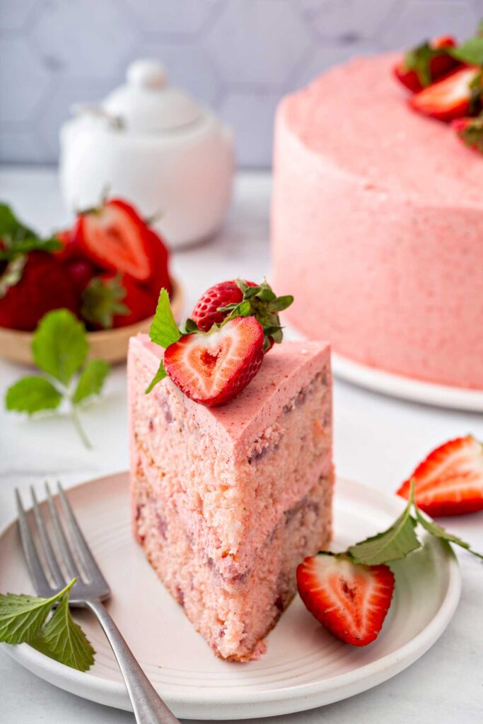 a slices of strawberry cake with strawberry halves on top