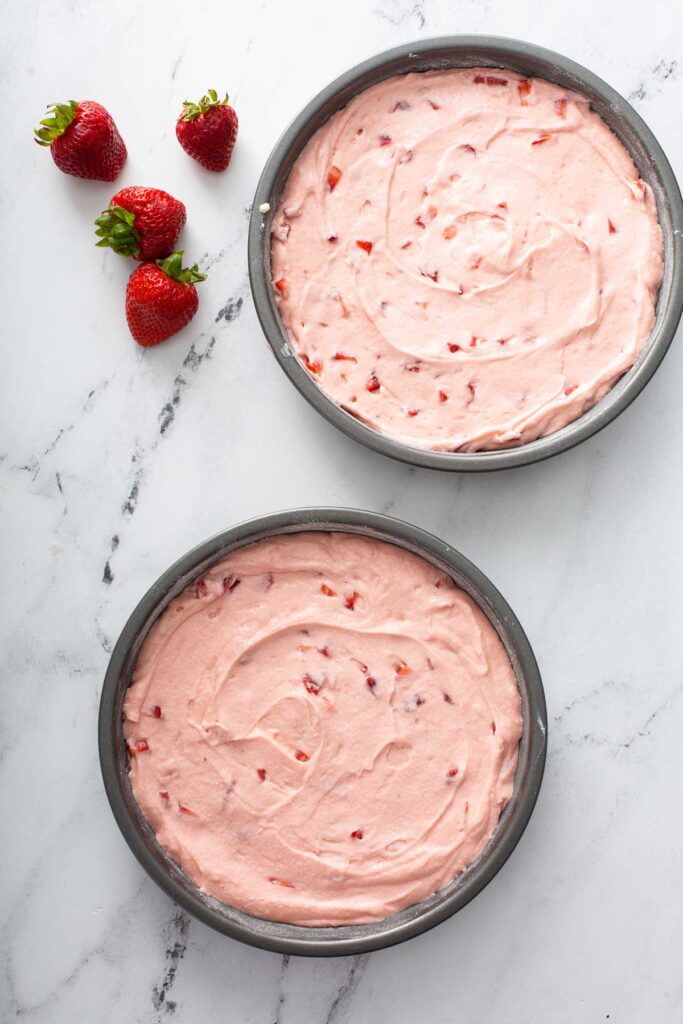 Strawberry Cake Batter divided in two round cake pans