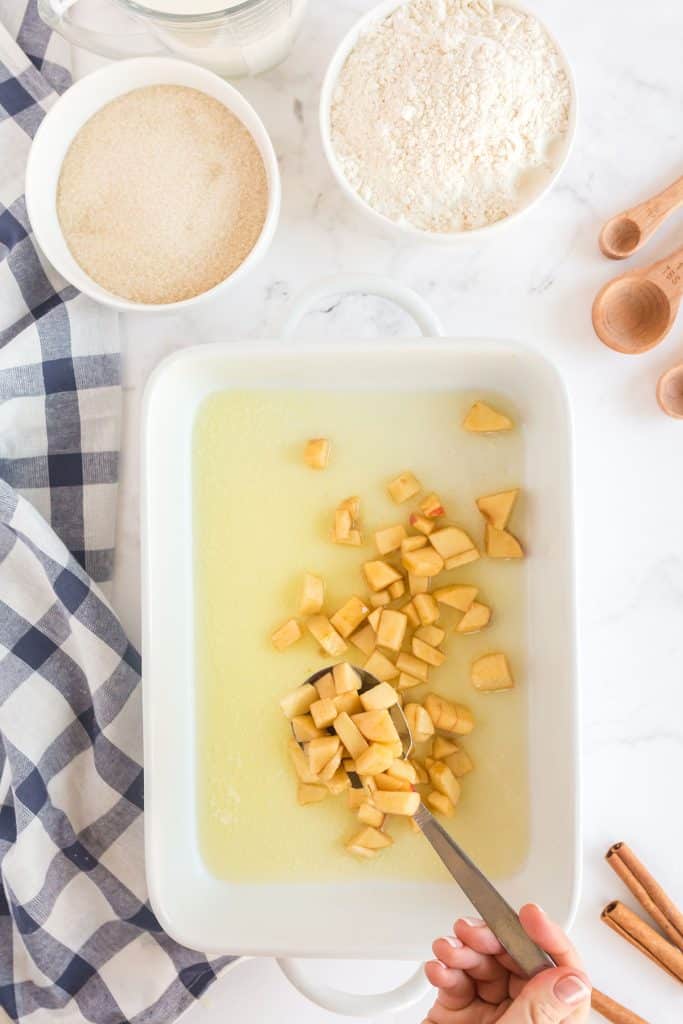 placing the sugared apples on a baking dish