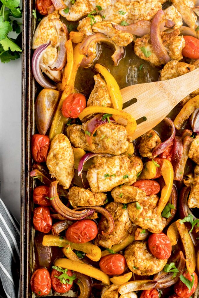 Close up view of chicken and veggies shawarma coming off the oven.