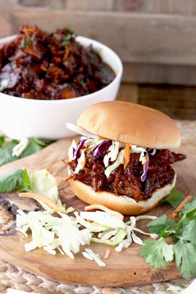 Pulled pork sandwich with coleslaw on a bun.