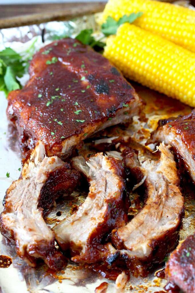 Golden brown tender BBQ ribs served with corn on the cob