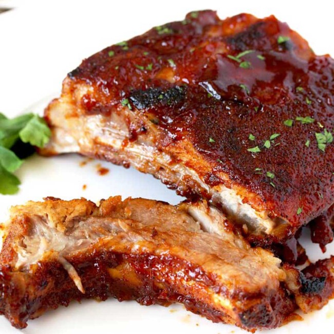Tender BBQ ribs served on a white plate