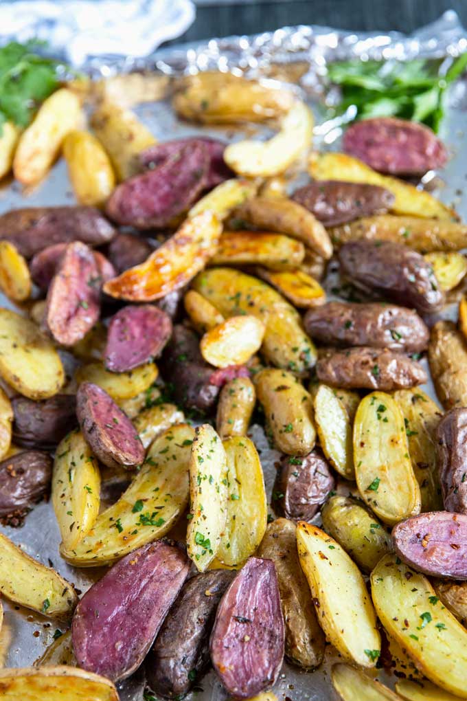 Crispy and tender roasted potatoes on a sheet pan.