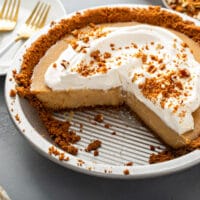Cut up creamy pie with whipped cream topping