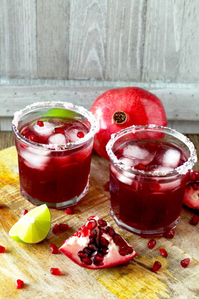 Glasses filled with the best pomegranate margarita on ice