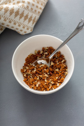 chopped pecans in a small white bowl