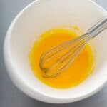 egg yolks in a large white bowl