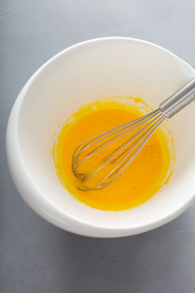 egg yolks in a large white bowl